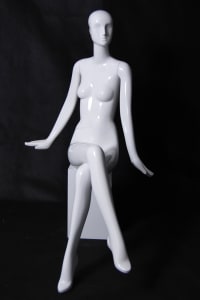 Glossy white abstract female seated mannequin for modern fashion retail display