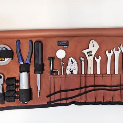 Pilot Tool Kit laid out with aviation tools, including wrenches, pliers, spark plug socket, and safety wire, all organized in a roll-up pouch.