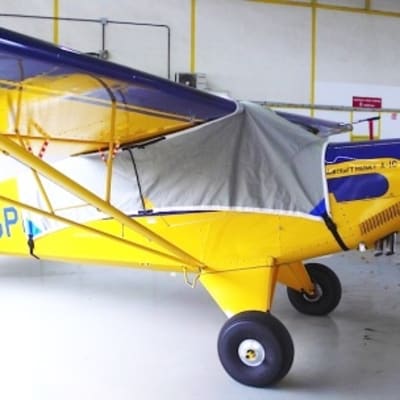Aviat Christen Husky aircraft with custom canopy, fuselage, engine, propeller, wing, and tail covers for sun and weather protection.