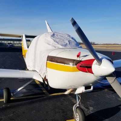 Beech Skipper B77 aircraft fitted with custom canopy, engine, and wing covers for all-weather protection.