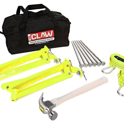 Millennium Outdoors C200 Claw RV Awning Anchor Kit with yellow aluminum anchors, spikes, straps, and hammer in a compact carry bag for wind protection.