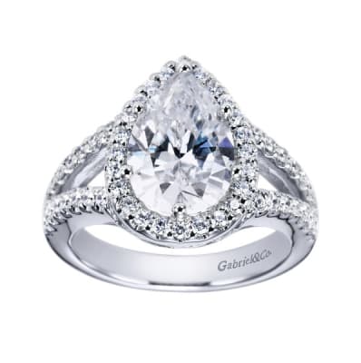Double rows of round brilliant diamonds greet  pear shaped diamond halo in this platinum engagement ring.