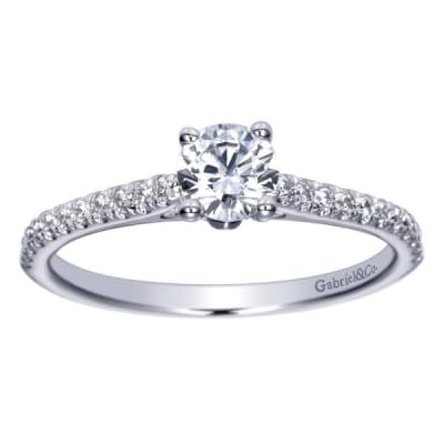 This stunning showcase favorite includes a round center diamond alongside side round diamonds, delivering the glimmer.