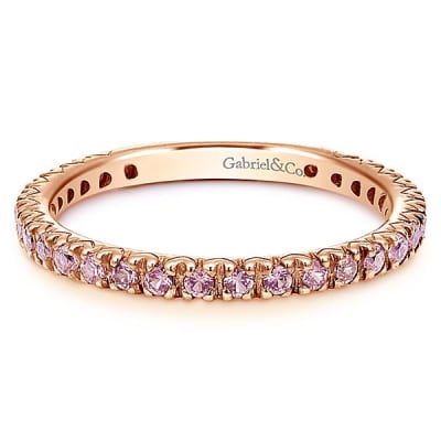 A row of pink sapphires set into 14k rose gold in this stackable ring.