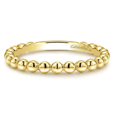 This 14k yellow gold stackable ring features beads.