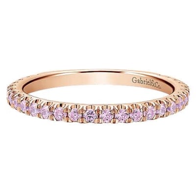 This 14k rose gold eternity stackable ring features pink stones.