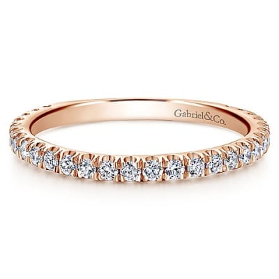 This 14k rose gold diamond stackable ring features a delicate row of shimmering diamonds that wrap around your finger.