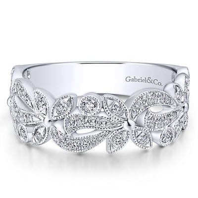 A 14k white gold diamond flower stackable ring with round brilliant diamonds.