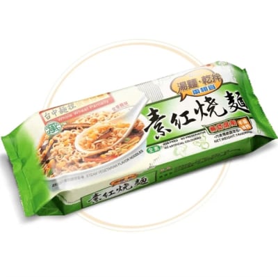 A bowl of vegetarian wheat noodles with cabbage, peas, corn, seaweed, and carrots in a light soy-based broth.