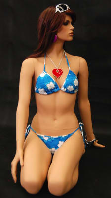 Realistic kneeling female mannequin in a fleshtone finish on a round metal base, featuring removable limbs for easy retail dressing.