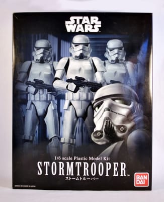 Photo box art of Star Wars Stormtrooper 1/6 model kit in a close up in the center facing forward flanked by additional Stormtroopers fading into the background.