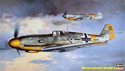 Box art illustration of Bf 109F scale model flying high in early morning sky with another Bf 109 in formation.