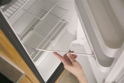 The Camco 45641 Refrigerator Door Stay. It is designed primarily for RV refrigerators to prop the door open during storage, which improves air circulation and prevents mold and odor buildup.