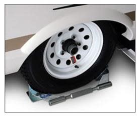 The BAL Single Axle Tire Locking Chock, model number 28020, is a stabilizing chock designed to prevent single-axle trailers from rolling. The single-chock design locks to both sides of the tire by tightening a center bar.