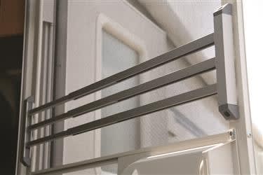 The Camco 43971 RV Aluminum Screen Door Push Bar, a durable and adjustable accessory designed to protect your screen door and provide a sturdier feel when opening and closing.