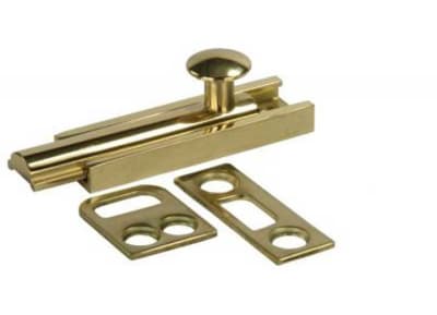 The JR Products 20635 3 Inch Surface Bolt - Brass, a deadbolt-style latch suitable for various door or cabinet applications.