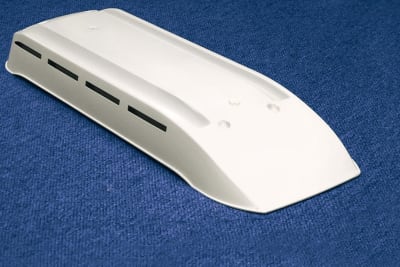The Norcold Refrigerator Vent White, model 622293CBW, is a low-profile plastic roof vent cap designed for RV refrigerators.