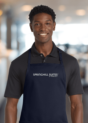 Restaurant-standard 65/35 poly/cotton twill bib apron. Durable 7.5-ounce, sliding neck adjustment, three patch pockets. 30" w x 31". Impressively embroidered with the SpringHill Suites logo.