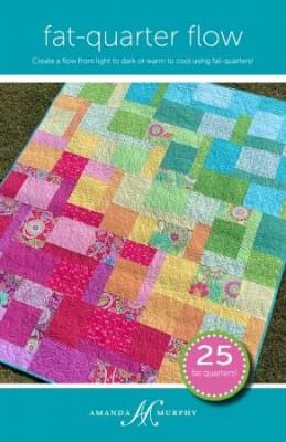 Fat Quarter Flow Quilt Pattern by Amanda Murphy shows a colorful quilt made with bright colored fat quarters.