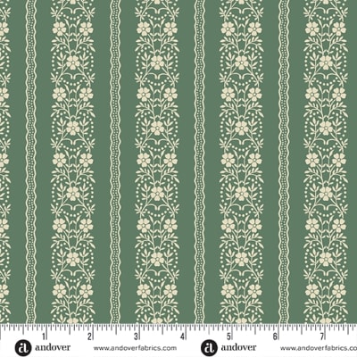 JOY Garland Stripe in Green by Laundry Basket Quilts shows a  small delicate cream floral motif on a medium green background  that alternates with a thin band of a lacy dotted design.