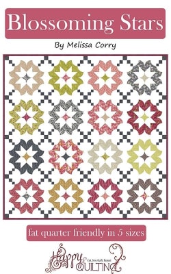 Blossoming Stars Quilts Pattern by Melissa Corry shows a pretty quilt in scrappy colors with blocks that look like star blossoms.