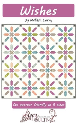 Wishes Quilt Pattern by Melissa Corry shows a pretty quilt in scrappy colors with  pieced blocks lad small star cornerstones.