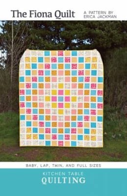 The Fiona Quilt Pattern by Kitchen Table Quilting shows a quilt with a straight quilt set of colorfuly pieced blocks.