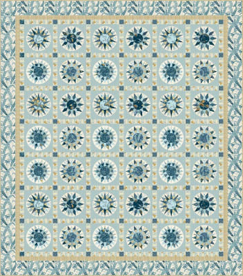 Monteray Quilt Pattern by Laundry Basket Quilts depicts a quilt with pre-printed cheater patchwork compass blocks in a straight set with sashing.