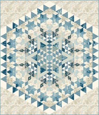 Blue Star Quilt Pattern  by Laundry Basket Quilt shows an interlocking quilt block in cream and shades of blue, and dark navy stars.
