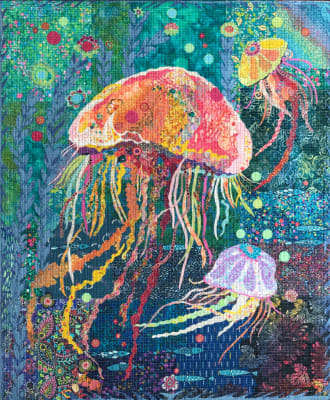 Jellie Fish Collage Quilt Pattern by Laura Heine shows a blue ocean fillled with a large jellie fish and several smaller jellie fish!