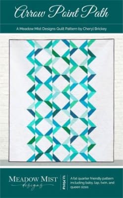 This quilt has a vertical design created by rows of half square triangles and is shown in shades of bright aqua and green on a white background.