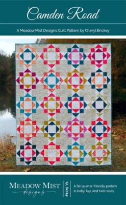 This quilt design features a traditional quilt block which was sewn in bright scrappy colors thru out the quilt .