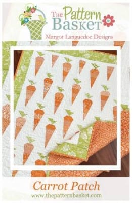 Carrot Patch Quilt Pattern by The Pattern Basket shows a small quilt with bright orange carrots.