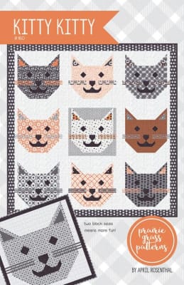 Purrfectly adorable kitty cat faces adorn the cover of this quilt pattern.