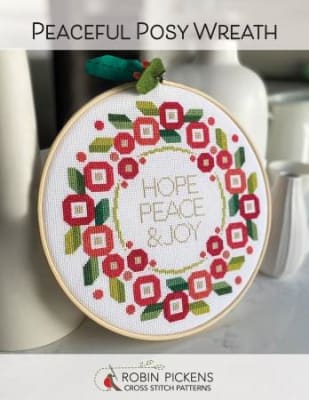 Peaceful Posy Wreath Cross Stitch Pattern by Robin Pickens s shpows a red, white and green wreath q on a white background.