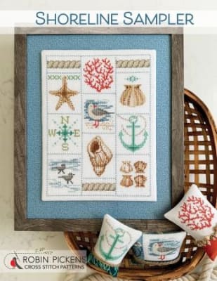 Shoreline SamplerCross Stitch Pattern by Robin Pickens shows a display of seashells, coral, a star fish , an anchor, and sandpipers, a compass and mariner's rope.