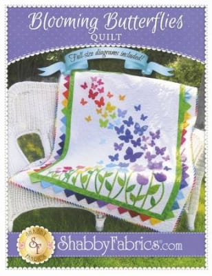 Blooming Butterflies Pattern by Shabby Fabrics shows an array of butterflies in bright colors on a white background with a pretty green border.