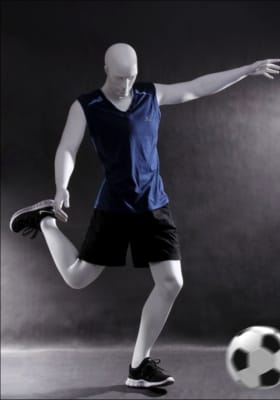 Male athletic soccer player mannequin scoring goal for sports apparel and retail display