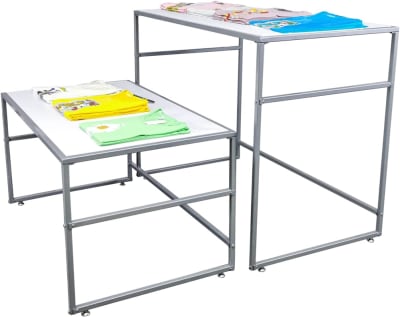 Set of white MDF nesting tables for retail display, stackable and used for showcasing jewelry, clothing, and accessories
