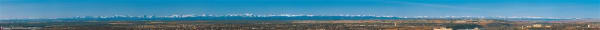 Calgary Mountain Panorama - Extra Large. This is a panoramic view of the City of Calgary facing west towards the Rocky Mountains. Features an overview picture of Calgary with mountains in the background. Names of each mountain is indicated on the poster.