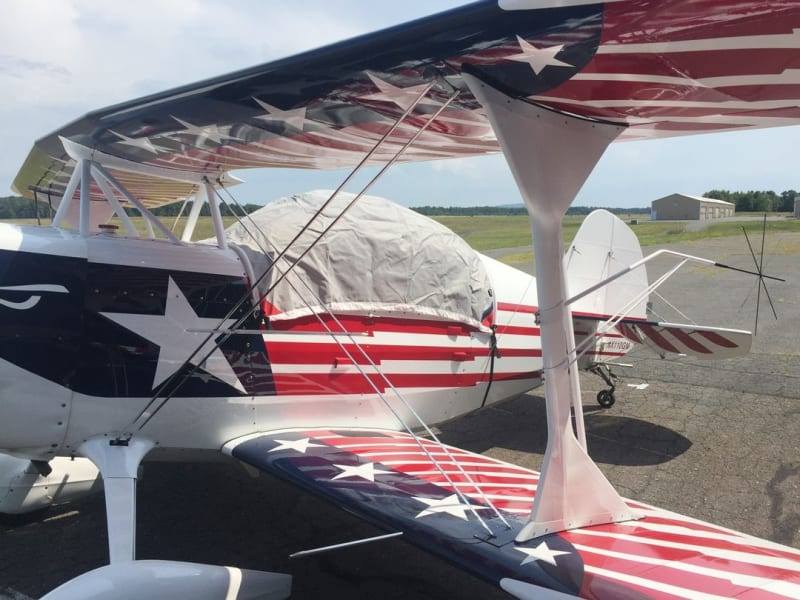 Aviat Christen Eagle with custom Silver Sunbrella canopy, engine, propeller, wing, and tail covers protecting from sun, snow, ice, and hail.