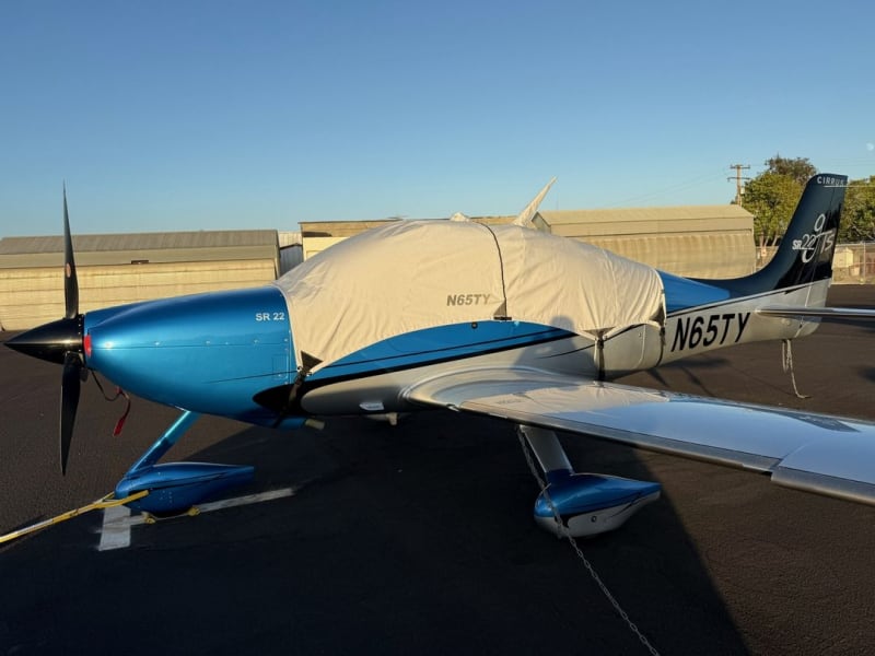 Cirrus SR22 with custom canopy, cockpit, fuselage, engine, propeller, wing, and tail covers installed outdoors.