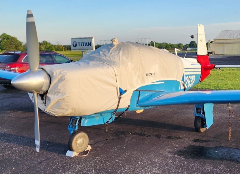 Custom-fitted Silver Acrylic Sunbrella canopy and engine covers on a Mooney Early M20 Series, protecting windows, fuselage, and engine cowl.