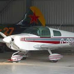 AeroTect paint protection film applied on Grumman Tiger wing root, nose wheel cover, and strut, protecting vulnerable painted surfaces from chips.