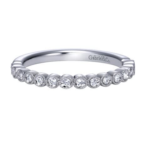 This simple and stylish diamond wedding band is featured in 14k white gold, to go along with 0.17 carats of round brilliant diamonds. This simple and stylish diamond wedding band is featured in 14k white gold, to go along with 0.17 carats of round brilliant diamonds.