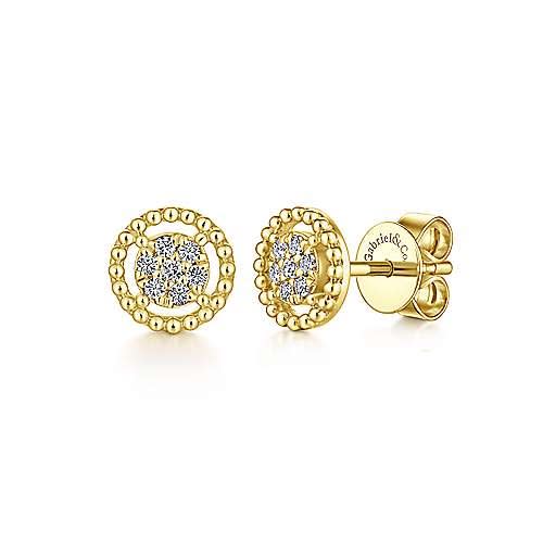 This pair of `4k yellow gold diamond stud earrings feature diamond accents floating in a beaded halo.