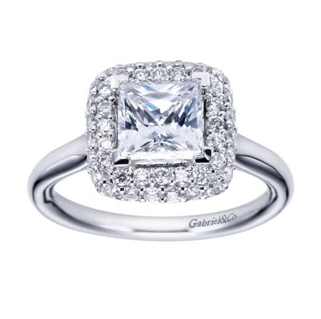 A double row of diamonds encapsulates a princess cut center diamond in this variation of a contemporary halo engagement ring.