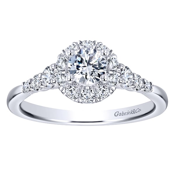 This white gold diamond engagement ring comes with a round center diamond and a beautiful round diamond halo to hold in all that shine! This white gold diamond engagement ring comes with a round center diamond and a beautiful round diamond halo to hold in all that shine!