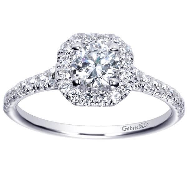 This 14k white gold diamond engagement ring uses round brilliant diamonds and a diamond halo to make its message! With 3/4 carats of round diamonds laid over sleek white gold the message is loud and clear! This 14k white gold diamond engagement ring uses round brilliant diamonds and a diamond halo to make its message! With 3/4 carats of round diamonds laid over sleek white gold the message is loud and clear!