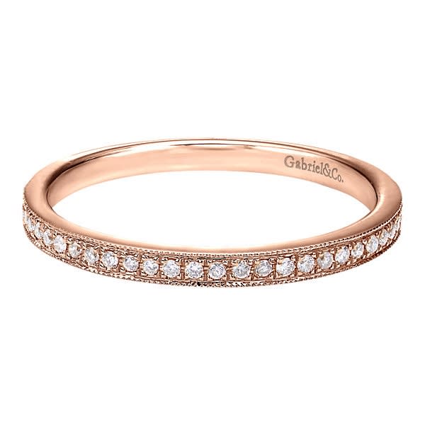 This 14k rose gold diamond stackable ring features round brilliant diamonds set in a delicate and modern rose gold band. This 14k rose gold diamond stackable ring features round brilliant diamonds set in a delicate and modern rose gold band.